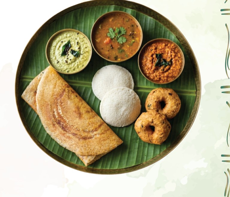 Crispy dosa, soft idly, vada and chutneys served on a banana leaf at Sri Arunachalam
