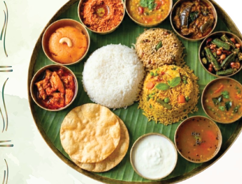 South Indian thali with rice, sambar, curries, biryani, papad and curd served on banana leaf